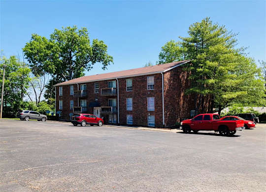 a large brick building with cars parked in front of it
