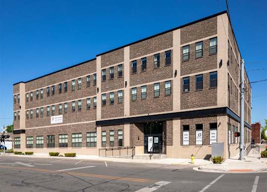 a large brick building on the corner of a street