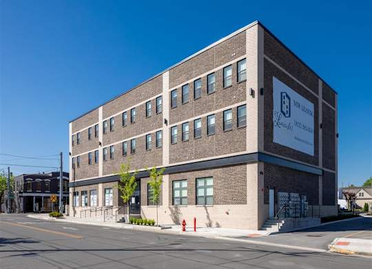 a large brick building on the corner of a street