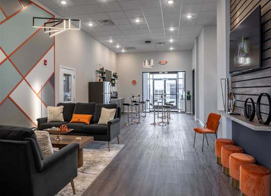 a living room with couches and chairs and a dining room table
