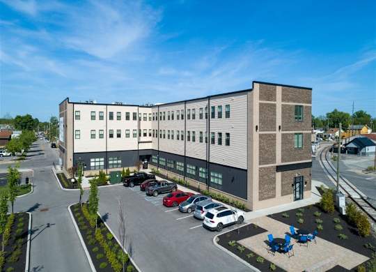 a large building with cars parked in a parking lot