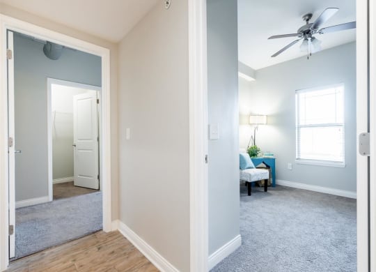 a living room with a ceiling fan and a mirror
