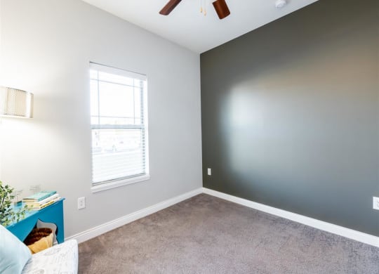 a bedroom with a ceiling fan and a window