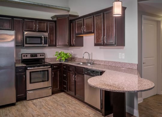 a kitchen with stainless steel appliances and granite counter tops