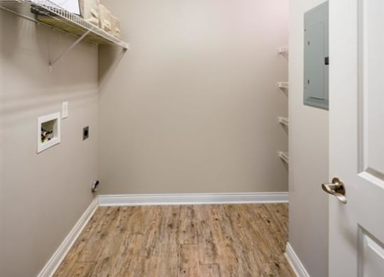an empty room with a wood floor and a closet