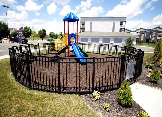 a playground in a yard with a slide