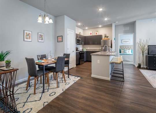 a dining room and kitchen with a table and chairs