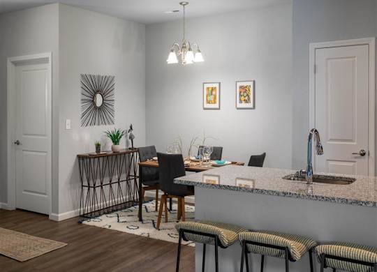 a kitchen and dining room with a table and chairs