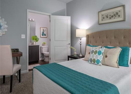 a bedroom with a bed and a bathroom