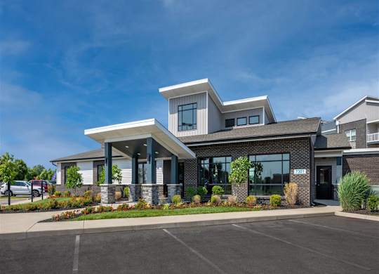 the front of a building with a parking lot