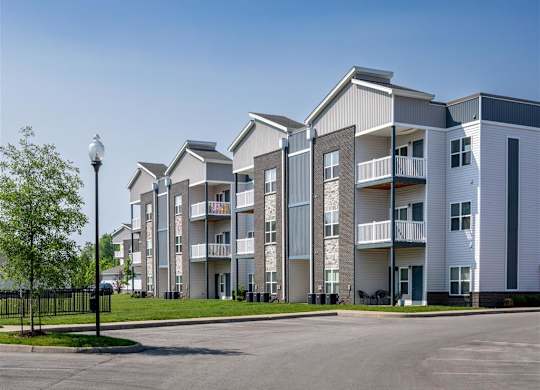 an empty parking lot in front of an apartment building
