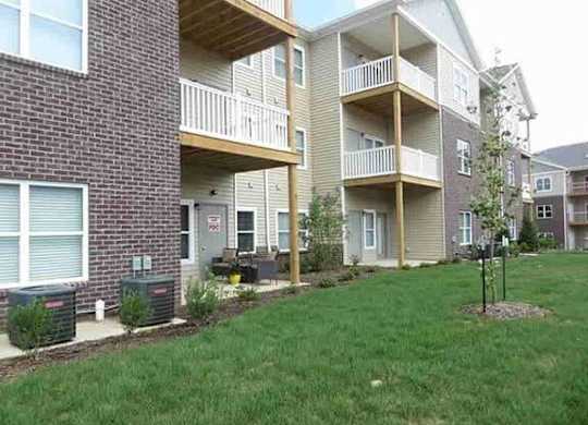 a man standing in front of an apartment building