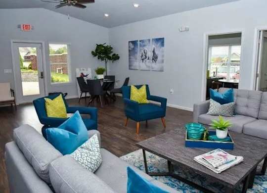 a living room with couches and chairs and a table