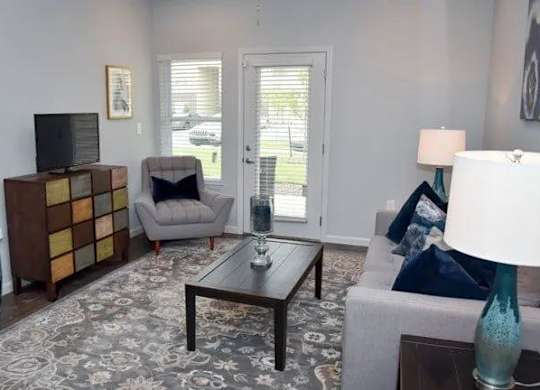 a living room with a couch a chair and a table