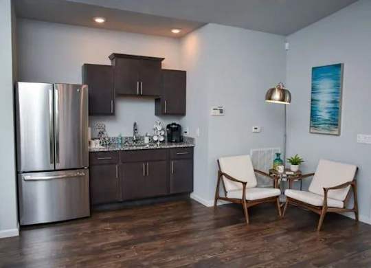 a kitchen with a stainless steel refrigerator and a table