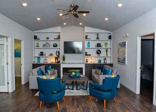a living room with a couch and chairs and a tv