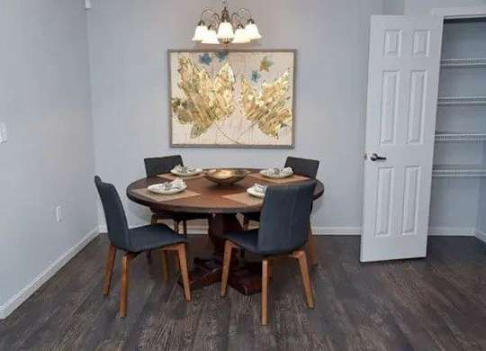 a dining room with a table and chairs