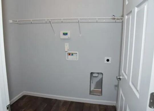 a bathroom with a toilet and a white wall