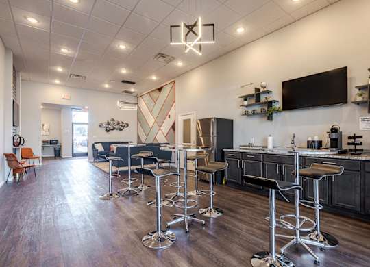 A bar area with a row of stools and a counter.