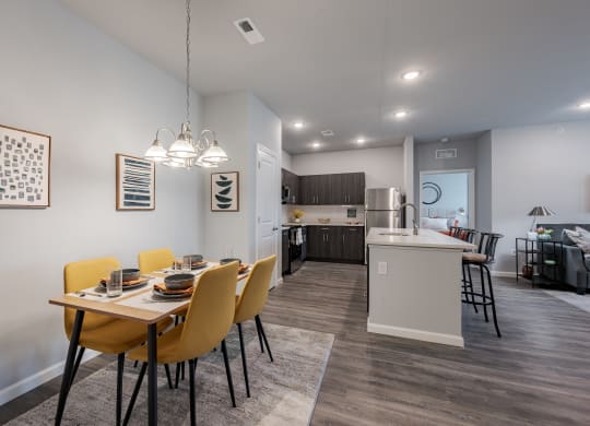 an open kitchen and dining room with a table and chairs