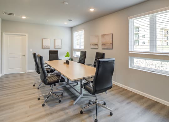 a conference room with a table and chairs and a window