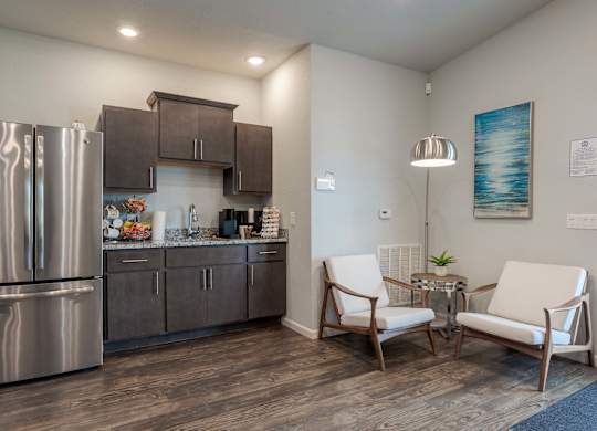 a kitchen with stainless steel appliances and a stainless steel refrigerator