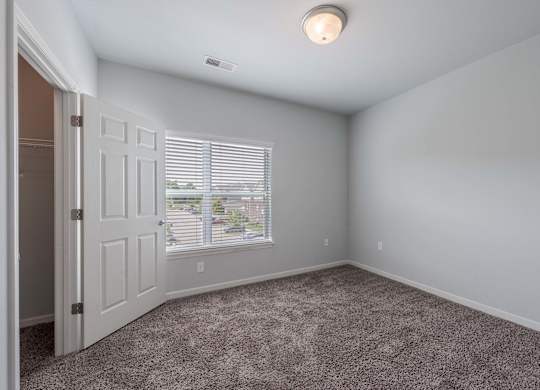 an empty room with a door and a window