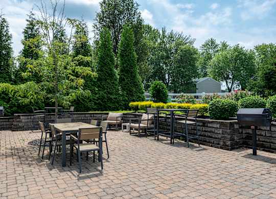 a patio with tables and chairs on a brick patio