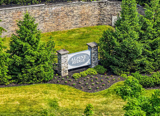 A sign that says All Ridge in front of a wall.