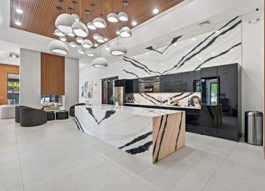 Modern lobby with marble reception desk and artistic ceiling lights at The Franklin at Marlboro Apartments, Marlboro, 07746