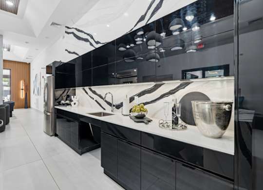 Modern kitchen with black cabinetry and marble backsplash at The Franklin at Marlboro Apartments, Marlboro, New Jersey