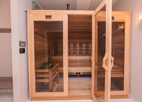 A sauna with wooden benches and a glass door.at The Franklin at Westfield, Westfield, 07090