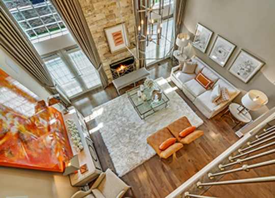 A living room with a glass table and a couch.