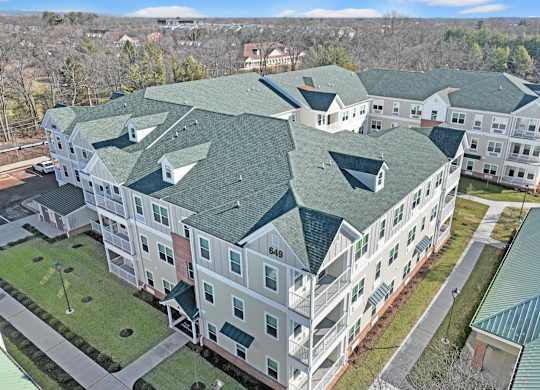 an aerial view of an apartment building with green roofs at The Franklin at Hillsborough Apartments, Hillsborough, NJ