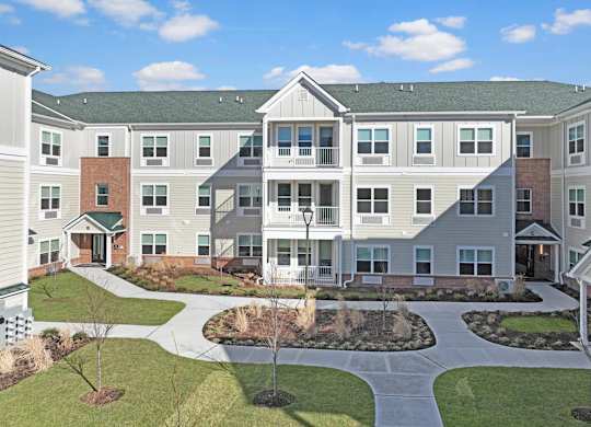 an exterior view of an apartment building with a courtyard at The Franklin at Hillsborough Apartments, NJ,08844