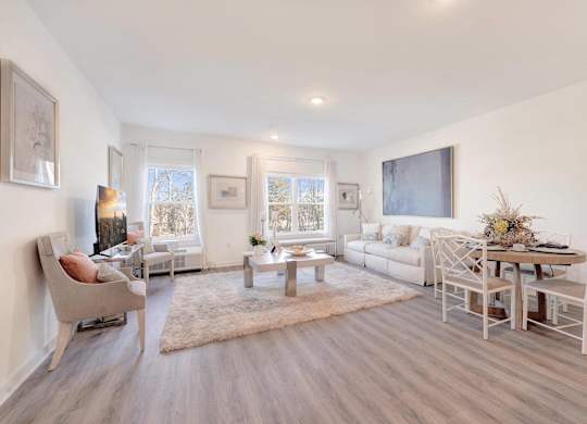 a living room with a couch and a table at The Franklin at Hillsborough Apartments, New Jersey