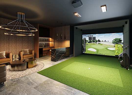 A room with a golf simulator and a couch.