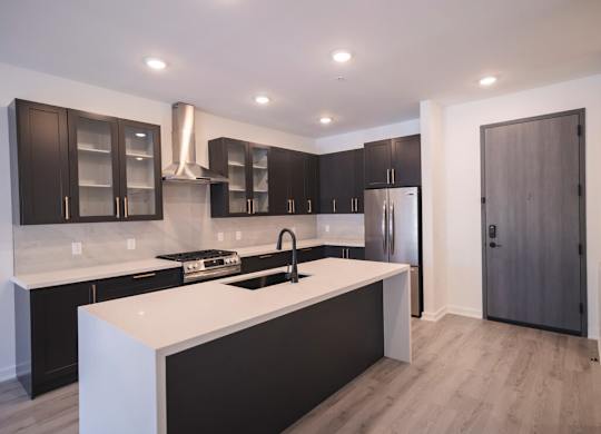 a kitchen with a white counter top and black cabinets at The Franklin at Westfield, New Jersey, 07090
