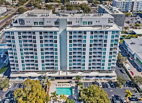 an aerial view of a large building with a pool and parking lot at Elements on Third Apartments, St. Petersburg, FL