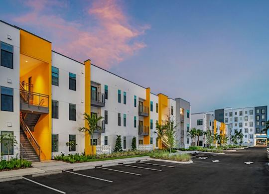 a row of apartment buildings with a parking lot in front of them at Elements on Third Apartments, Florida, 33713