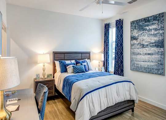 a bedroom with a bed and a ceiling fan at Elements on Third Apartments, St. Petersburg, Florida