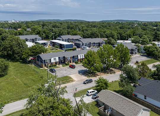 A large building complex with a parking lot in front.