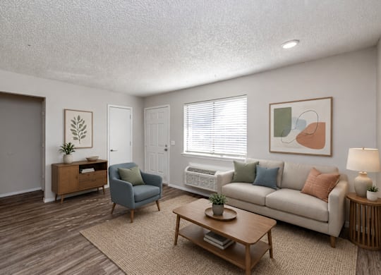 A living room with a couch, chair, and coffee table.