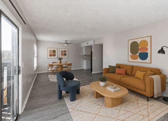 A living room with a blue chair, a yellow couch, and a painting on the wall.