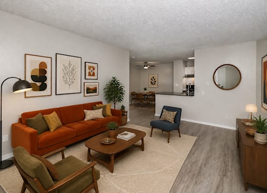 A living room with a couch, chair, and a table.