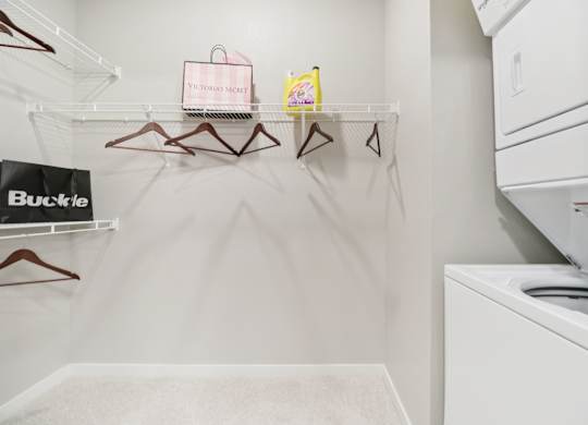 A white laundry room with a washer and dryer.