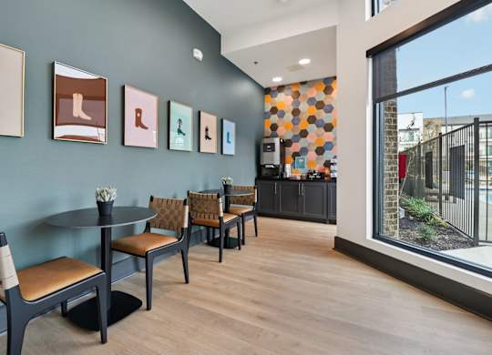 A room with a table and chairs and pictures on the wall.