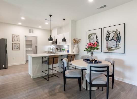 A dining room with a table set for four.