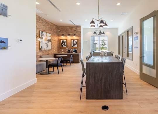 A modern kitchen with a wooden island and chairs.