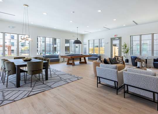 A spacious living room with a dining table and chairs.